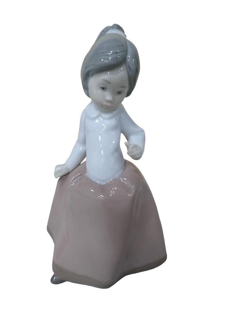 Nao by Lladro Young Girl with a Ponytail Porcelain Figurine: Nao by Lladro Young Girl with a Ponytail Porcelain Figurine