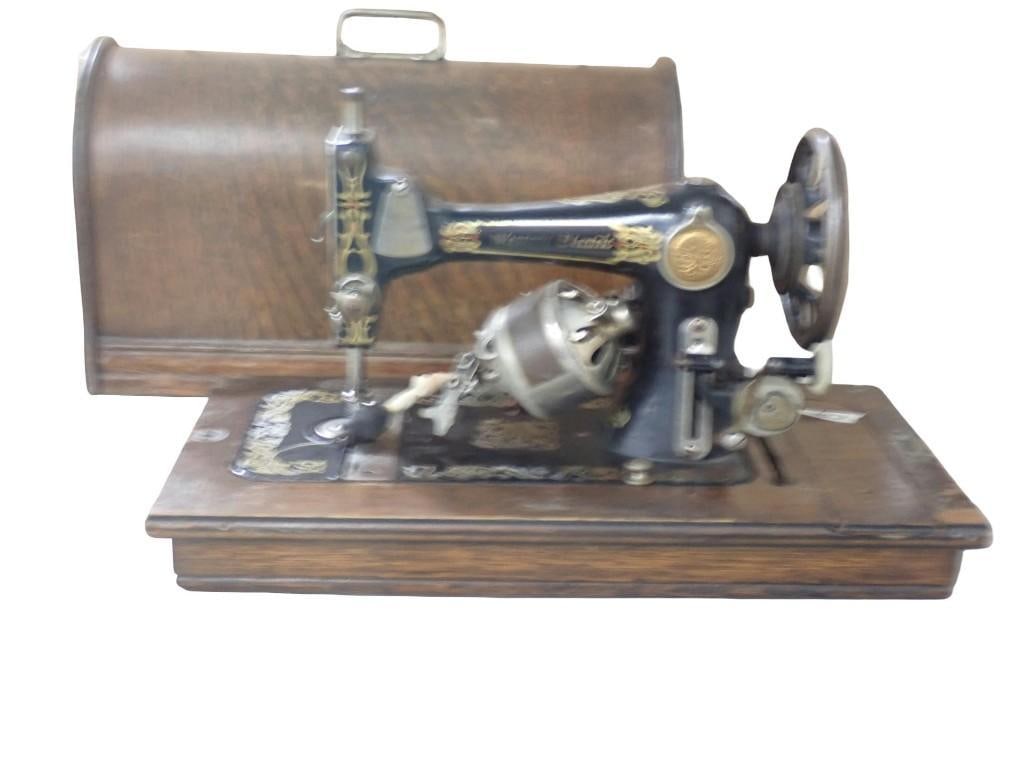 Vintage or Antique Western Electric Sewing Machine with Wooden Case: Vintage or Antique Western Electric Sewing Machine with Wooden Case All pictures are considered part of the description and should be examined carefully by bidders. Live Auctioneers is now offering Li