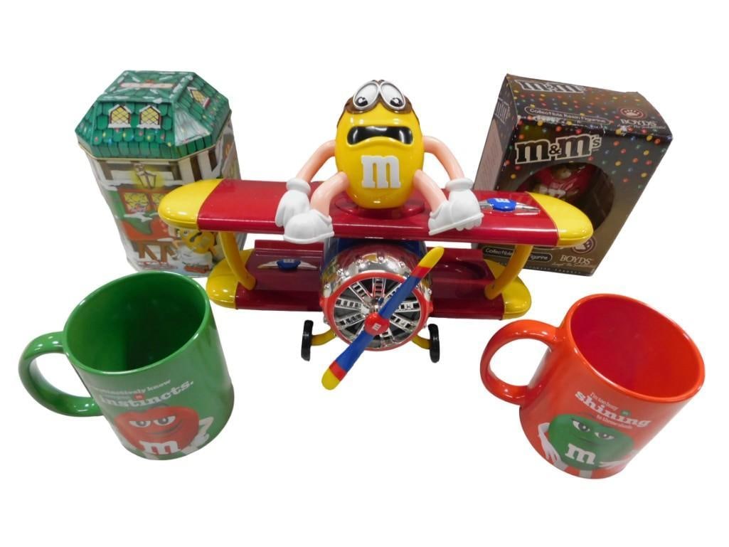 M&M's Collectible Toy Lot including Airplane, Mugs, Boyds Bear Figurine: M&M's Collectible Toy Lot including Airplane, Mugs, Boyds Bear Figurine All pictures are considered part of the description and should be examined carefully by bidders. Live Auctioneers is now