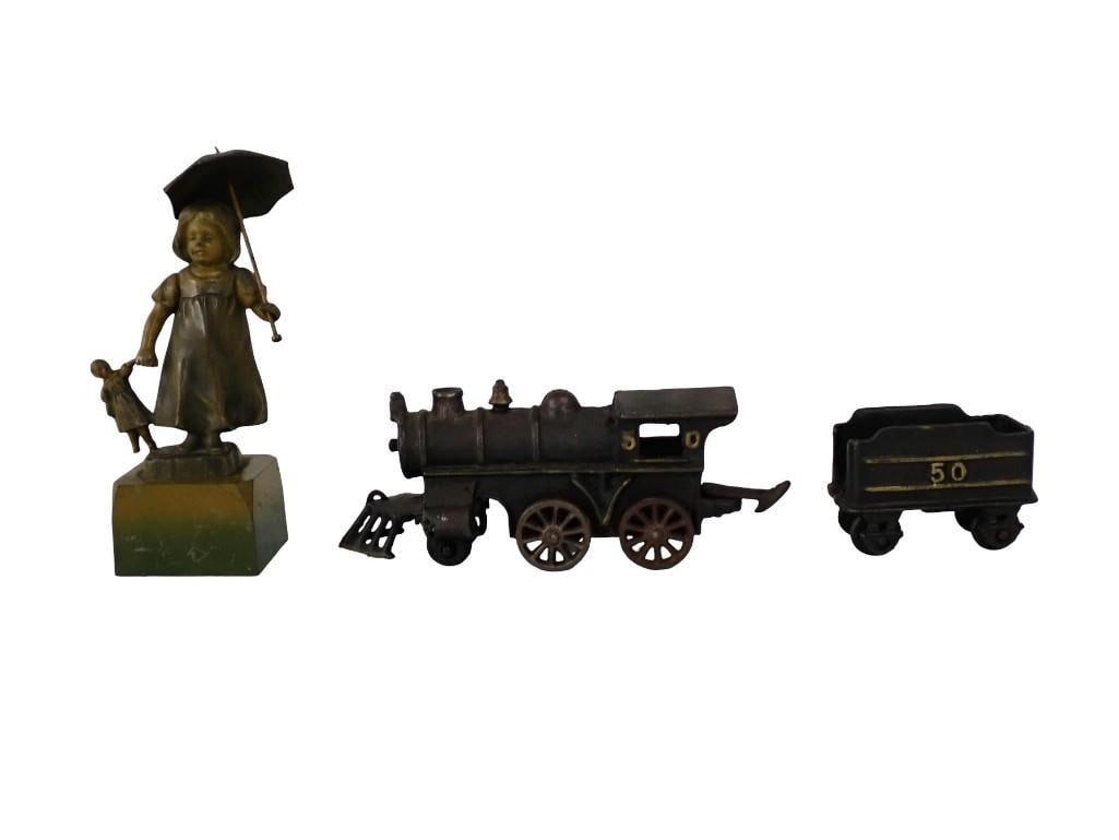 Cast Lot including Girl with Doll Figurine, Train Engine and Coal tender: Cast Lot including Girl with Doll Figurine, Train Engine and Coal tender All pictures are considered part of the description and should be examined carefully by bidders. Live Auctioneers is now offeri