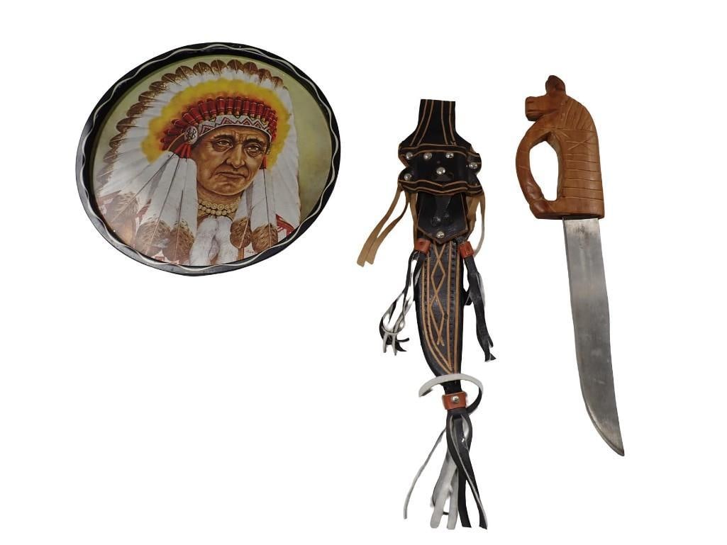 2 Knives incl 1 with a Carved Handle and 1 with a Leather Sheath and a Native American Tray: 2 Knives incl 1 with a Carved Handle and 1 with a Leather Sheath and a Native American Chief Tray. The knife with the carved handle says "Promedoca La Vega Rep. Domicana" on it All pictu