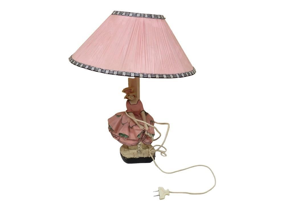 Figural table lamp with hand-painted ceramic lady in pink ruffled dress: Figural table lamp with hand-painted ceramic lady in pink ruffled dress All pictures are considered part of the description and should be examined carefully by bidders. Live Auctioneers is now offerin