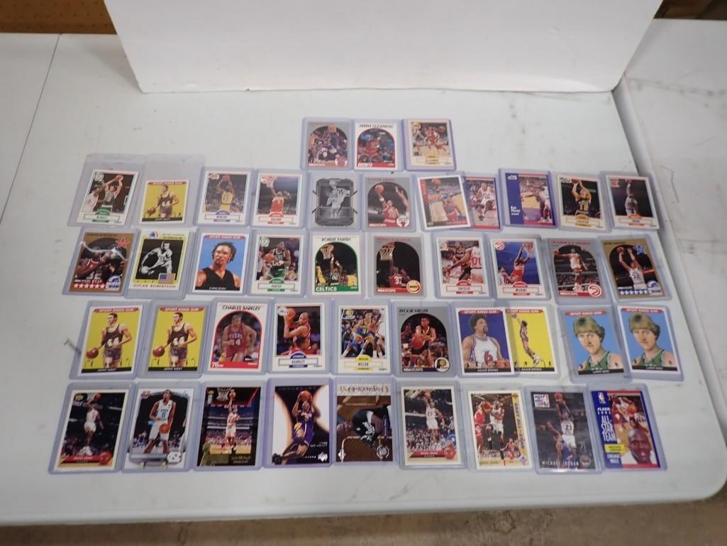 Basketball Cards including Michael Jordan, Larry Bird, Akeem Olajiwon, Julius Erving, etc.: Basketball Cards including Michael Jordan, Larry Bird, Akeem Olajiwon, Julius Erving, etc. All pictures are considered part of the description and should be examined carefully by bidders. Live Auction