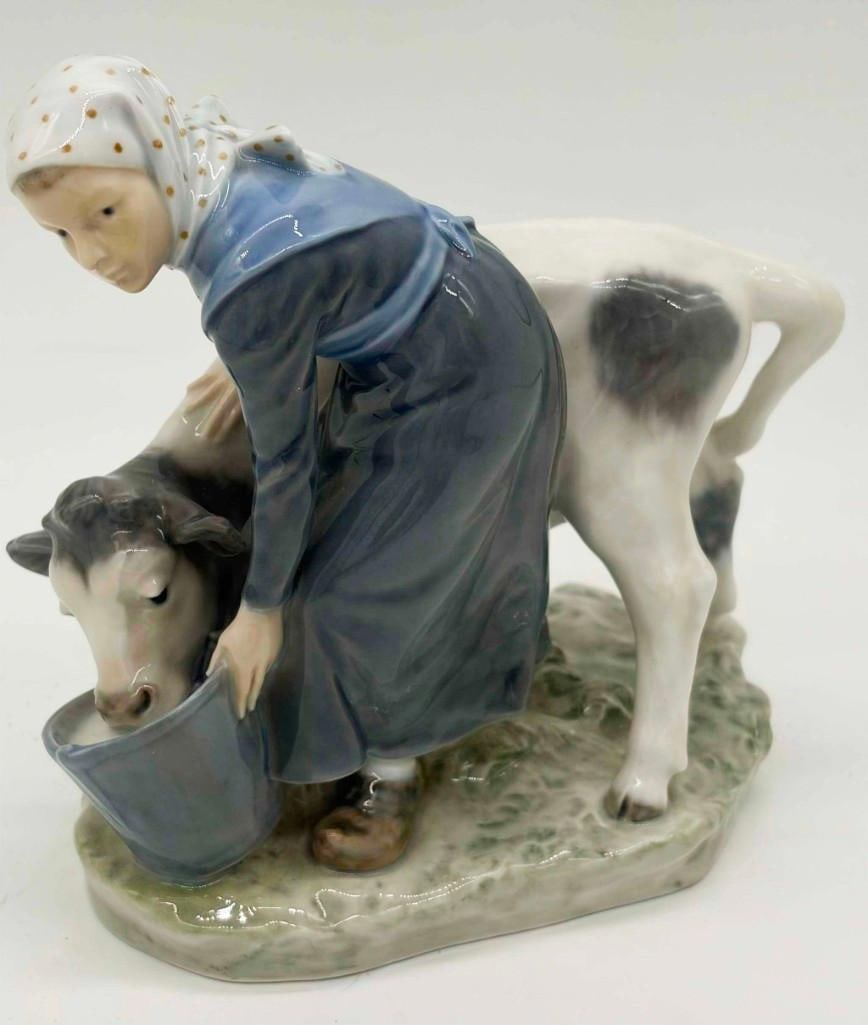 Royal Copenhagen 779 Girl Feeding Calf Figure: Royal Copenhagen 779 Girl Feeding Calf Figure. No Chips, Very nice. . All Pictures Are Considered Part Of The Description And Should Be Examined Carefully By Bidders.. Live Auctioneers Is Now Offering
