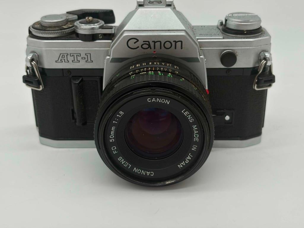Vintage Canon At-1 Slr Camera W/ Fd 50mm Lens: Vintage Canon At-1 Slr Camera W/ Fd 50mm Lens. Untested. . All Pictures Are Considered Part Of The Description And Should Be Examined Carefully By Bidders.. Live Auctioneers Is Now Offering Live Shipp