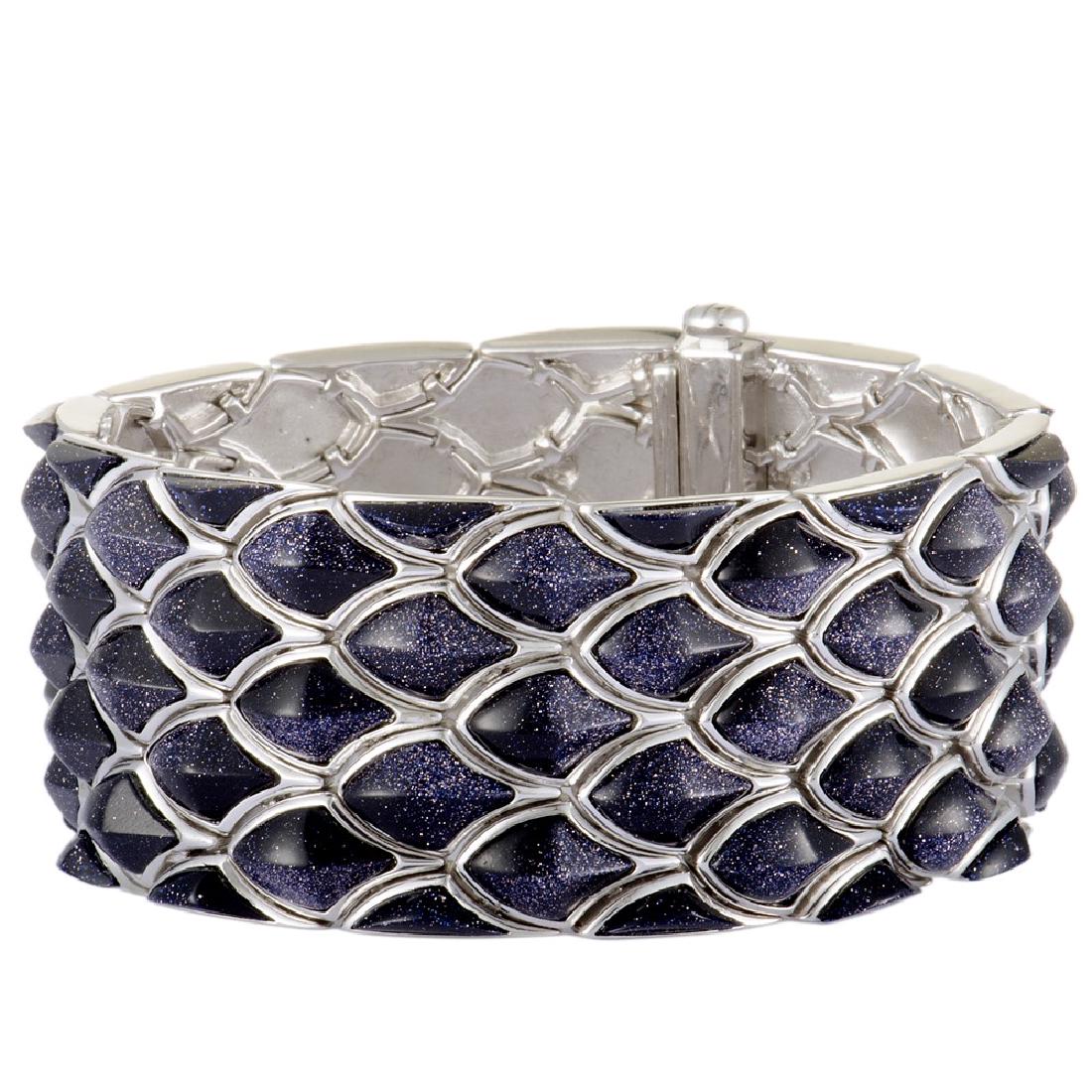Stephen Webster Superstud Silver Navy Blue Goldstone: This fabulous jewelry piece boasts an exceptionally attractive design that compels with its bold offbeat shapes that are spectacularly topped off with expertly cut and magnificently toned gems. The br