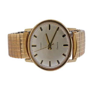 Timex Electric Wrist Watch: Metal Content: Gold Tone top, Stainless Steel back. Dial: Silver tone Timex, with applied markers.Size: Diameter of the case - 35mm. Stretch band. Movement: Electric. Non working. Marks: Waterproof.