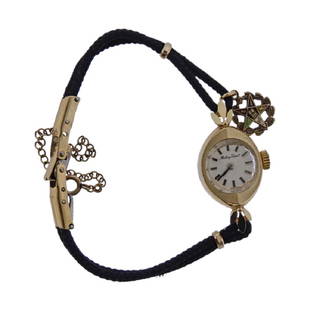 Mathey Tissot 14k Gold Women's Wrist Watch: Metal Content: 14k Gold (case), Base Metal and fabric (band)Dial: Mathey Tissot signed dial with applied silver tone markers, original faceted crystal. Size: Case - 14.5mm x 30mm, fancy lugs. Band