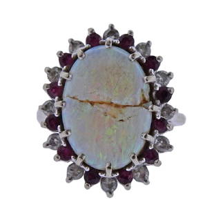 14k Gold Diamond Opal Ruby Ring: Metal Content: 14k Gold. Weight of Item: 6.4 grams.Size: Ring size - 5, top - 22mm x 18mm. Gemstone: Opal (cracked), Diamonds, Rubies. Carat Weight: 0.30ctw.Stamp: 14k (polished off).