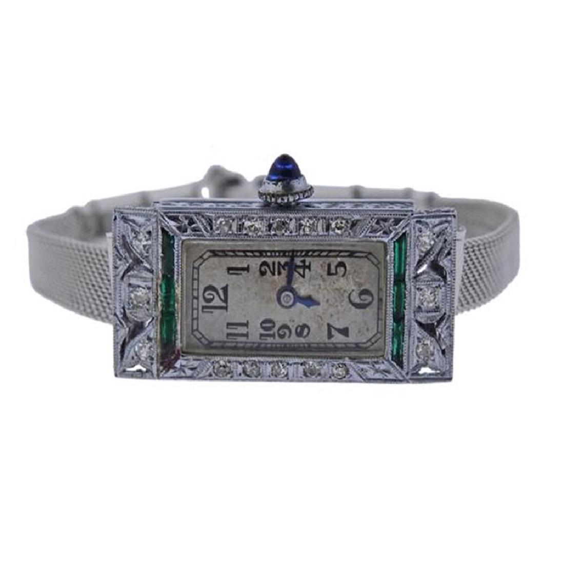 Art Deco 1920s Concord 18k Gold Diamond Watch: Metal Content: 18k Gold (case). Weight of Item: 15.8 grams. Gemstone: Diamond, Emerald. (chipped) Size: Case - 14.5mm x 30.5mm. Length of the bracelet - 6.5". Movement: Manual Wind. Not running. 