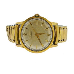 Movado Gold FIlled Stainless Steel Automatic Watch: Metal: Gold Filled/ Stainless Steel. Dial: light gold tone dial with gold tone Arabic numeral/stick markers and hands Multiple fractures on crystal.Size: case-34mm without crown. Full size flexible