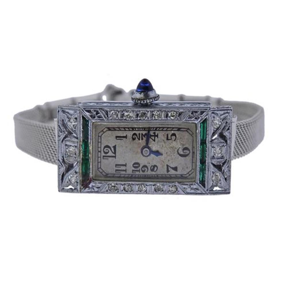 Art Deco 1920s Concord 18k Gold Diamond Watch: Metal Content: 18k Gold (case). Weight of Item: 15.8 grams. Gemstone: Diamond, Emerald. (chipped) Size: Case - 14.5mm x 30.5mm. Length of the bracelet - 6.5". Movement: Manual Wind. Not running.