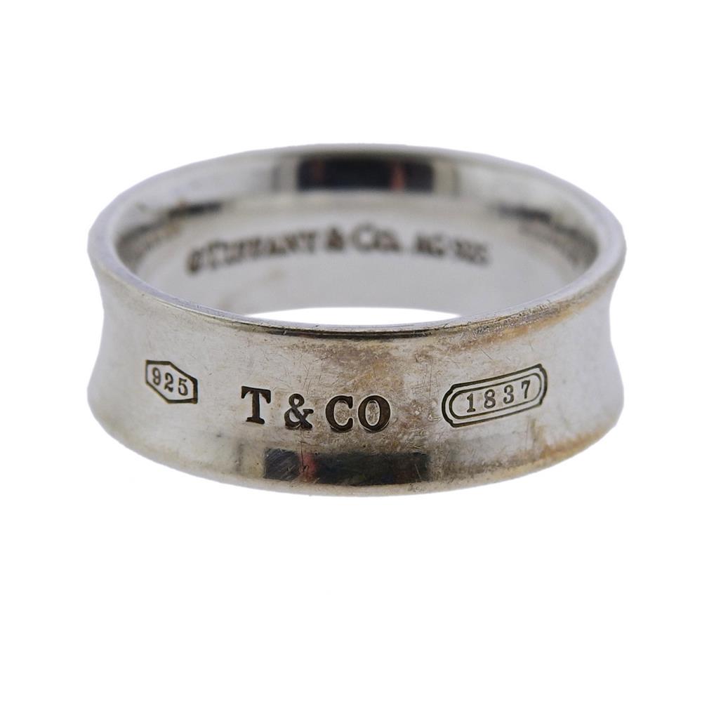 Tiffany & Co Sterling Silver 1837 Wedding Band Ring: Metal Content: Sterling silver.Weight of Item: 5.7 grams.Size: Ring size 9. Band 7mm wide.Stamp: Tiffany & Co AG925