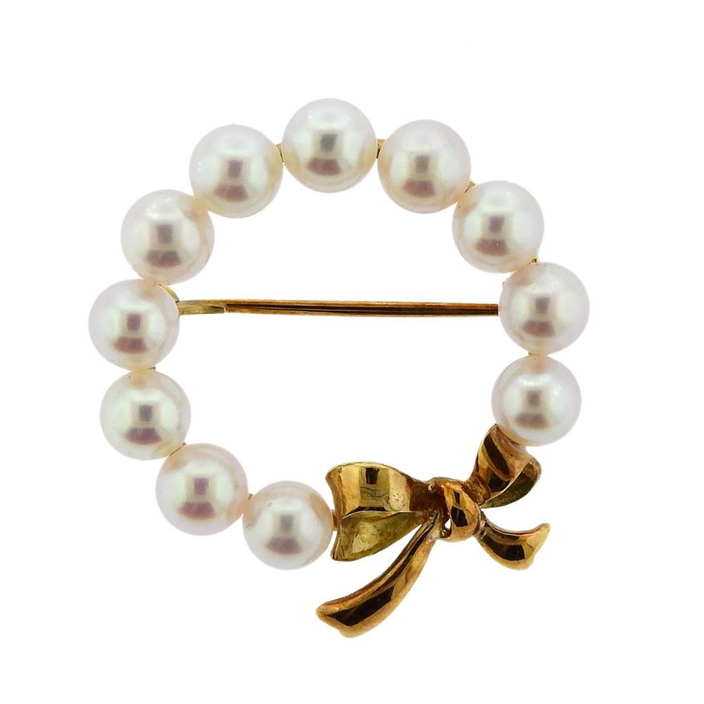 Mikimoto 14K Gold Pearl Brooch: Metal Content: 14k Gold.Weight of Item: 5.9 grams.Size: Brooch is 27mm in diameter.Gemstone: Pearls 5.3mm..Stamp: M 585.
