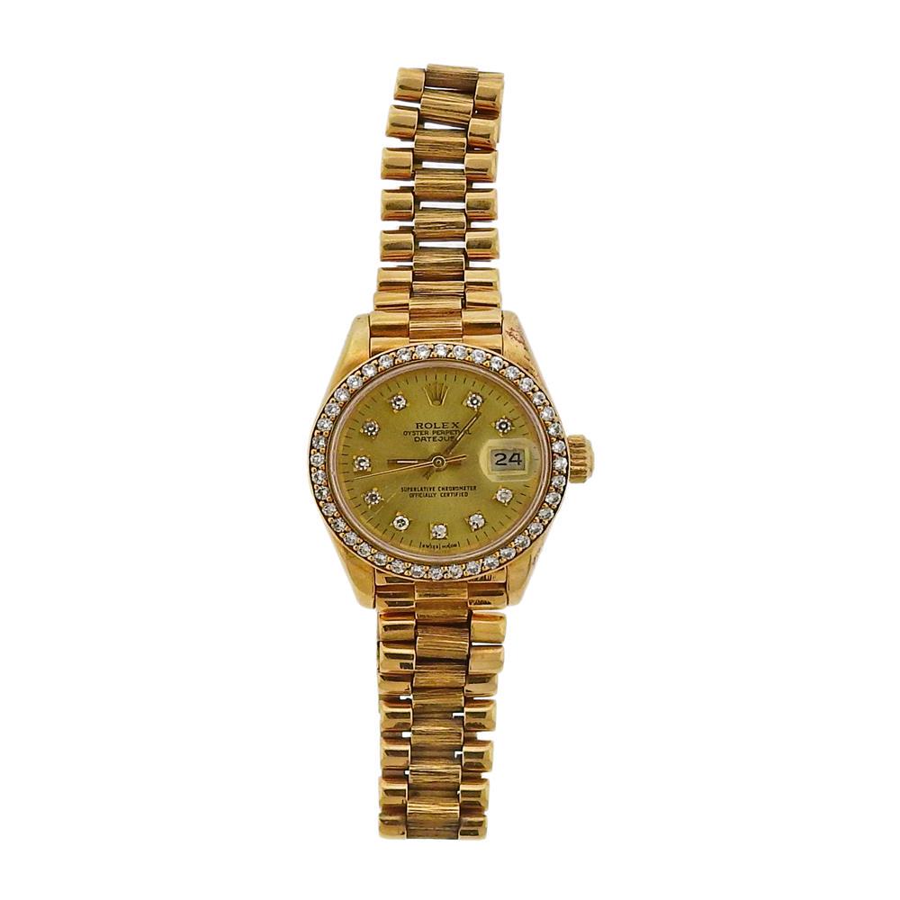 Rolex President Diamond 18k Gold Champagne Dial: Metal Content: 18k Gold. Dial: Champagne Rolex dial with diamond marks and bezel, date at 3 o'clock. Size: Case - 26nn excl crown, jubilee bark finish 18k gold band - will fit up to 7.25" wri