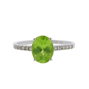 14K Gold Diamond Peridot Ring: Metal Content: 14k White Gold.Weight of Item: 2.4 grams.Size: Ring is 7 1/4, ring top - 9mm at widest point.Gemstone: Diamonds. Peridot - 9 x 7 x 4.5mm.Carat Weight: approx. 0.10ctw.Stamp: 14K ID.