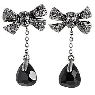 Pomellato Forever 18K WG Onyx Black Diamond Earrings: This pair of Pomellato Forever bow earrings are feminine and unique. They are made of 18K blackened white gold. The bow is diamond pave with .64CT of black diamonds and features large onyx gemstones.