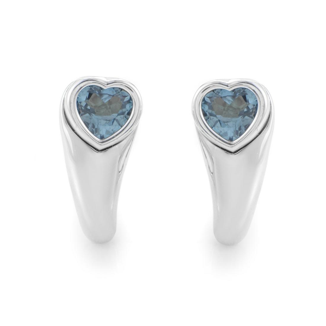 Piaget Women's 18K White Gold Topaz Heart Earrings: Everenchanting and irresistibly romantic, the lovely heart motif is presented in this magnificent pair of earrings from Piaget in a cool, gleaming fashion owing to the wonderfully polished 18K white g