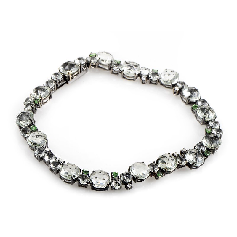 A Furst Antonini Green Amethyst Tennis Bracelet: Gorgeous green gemstones stud this unique tennis bracelet from A Furst to make a truly lovely design. The bracelet is made of black rhodiumtreated 18K white gold and is set with amethysts of varying s