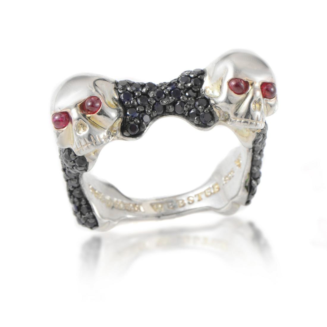 Stephen Webster Skull Bones Silver Ring - 11: Designed for men with strong focus on offbeat masculine elements, this impressive Stephen Webster ring is made of silver and boasts eyecatching decoration in form of two skulls set with four rubies to