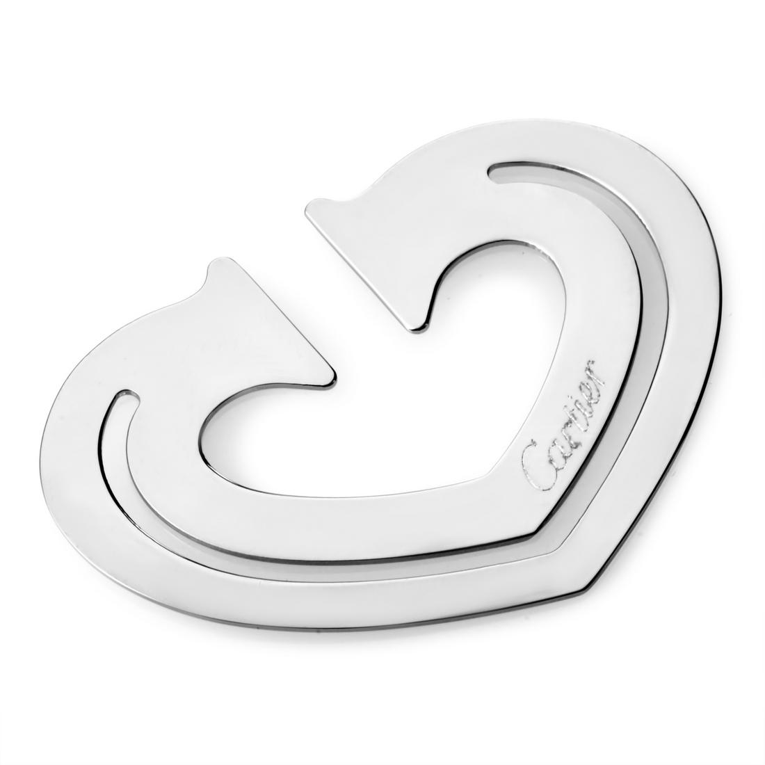 Cartier Stainless Steel Heart Bookmark T1220265: A creatively glamorous addition to one's lifestyle, this Cartier bookmark shaped like a heart is a stainless steel gem.