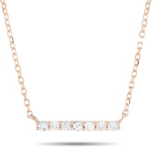 14K Rose Gold 0.10 ct Diamond Necklace: This necklace is crafted from 14K rose gold and weighs 1.3 g. It is presented with a 15 chain and boasts a pendant that measures 0.07 in length and 0.44 in width. The necklace is set with diamonds