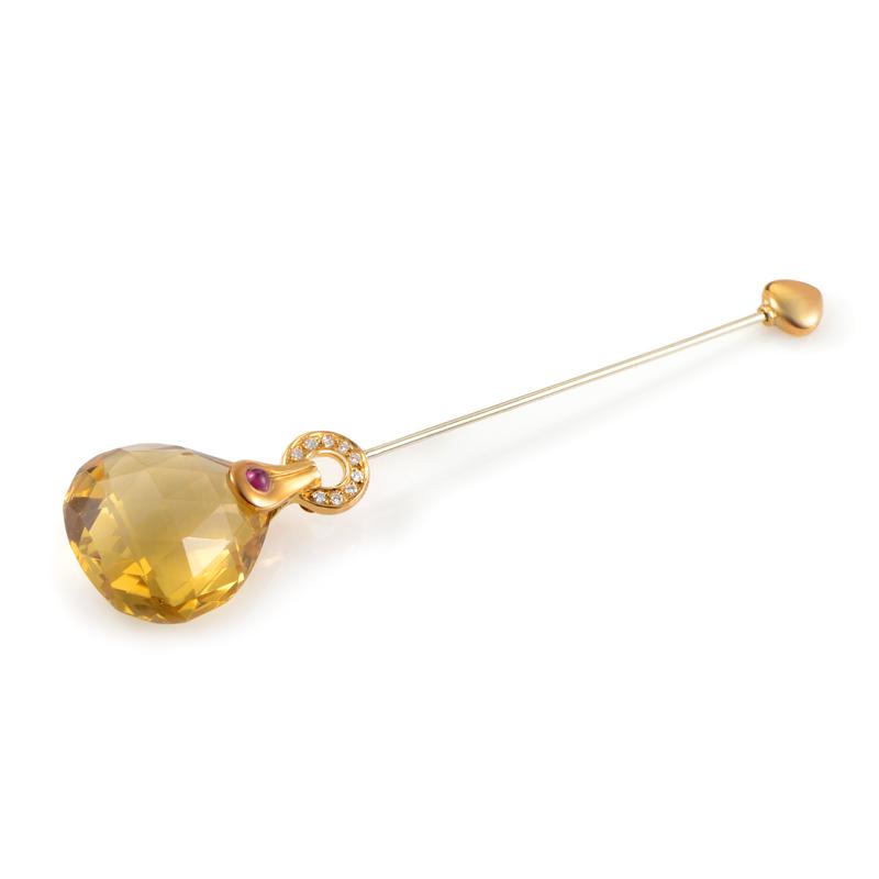 Antonini 18K Yellow Gold Gemstone Pin: A delightful, wonderfullycut citrine stone takes the central spot of this enchanting pin from Antonini, set on a delicate 18K yellow gold base embellished with diamonds and a strikingly contrasting ru