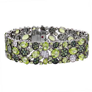 Roberto Coin 18K WG, Peridot, Diamond Bracelet: Lavish, tasteful and exceptionally joyful, this magnificent 18K white gold bracelet from Roberto Coin employs the fascinating beauty of diversely nuanced peridot stones weighing in total 32.15 carats