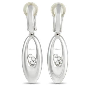 Chopard Happy Diamonds 18K White Gold 0.18 ct Diamond Earrings: A trio of floating diamonds totaling 0.18 carats sit at the center of these sleek, sophisticated Chopard Happy Diamond earrings. Crafted from 18K White Gold, each one features a dramatic ovalshaped