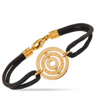 Bvlgari 18K Yellow Gold and Leather Bracelet: A lustrous 18K Yellow Gold pendant engraved with the luxury brands moniker gives this Bvlgari bracelet a classic sense of elegance. The precious metals contrast beautifully against the rough leather