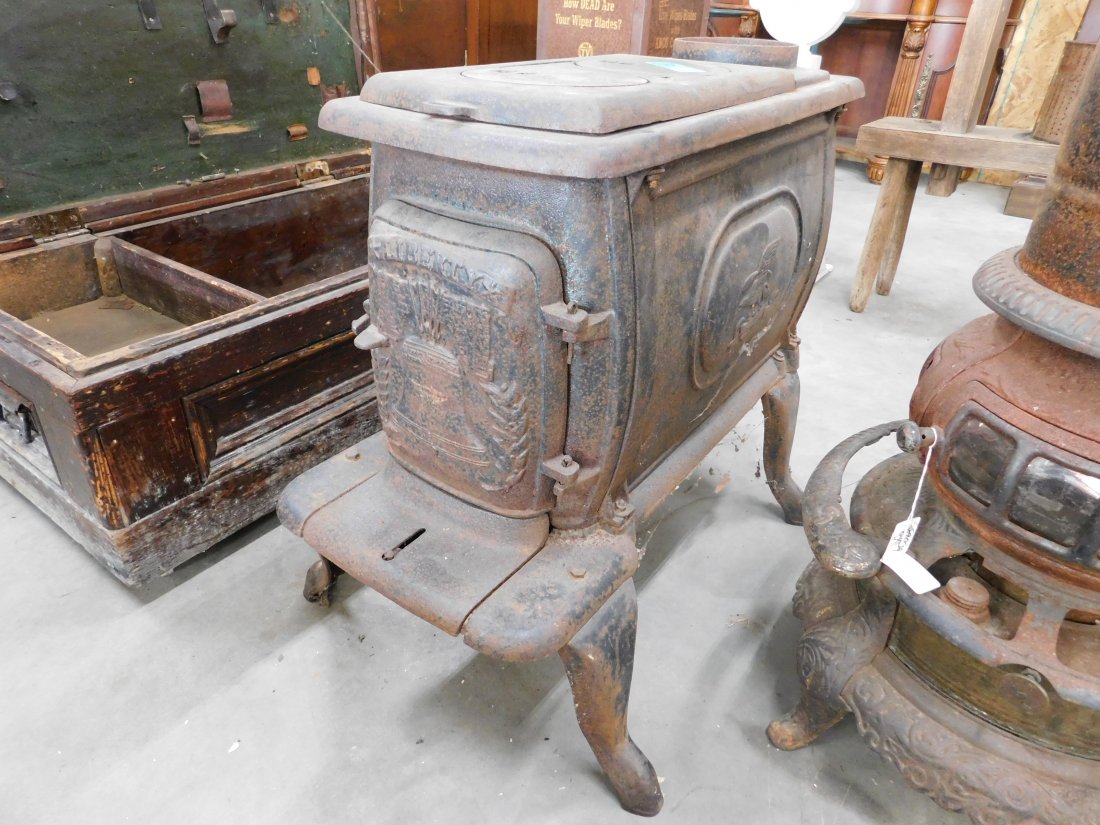 Liberty Cast Iron Wood Stove: Liberty 2 burner cast iron wood stove, minor rust, appears complete, overall good condition, 30 inches long, 19 inches wide, 24 inches high