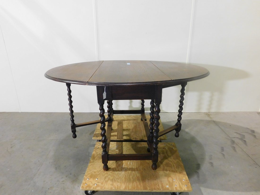 Oak Drop-Leaf Table: Oak drop-leaf table with fancy turned legs. Approximately 42 inches wide, 28 1/4 inches tall, 21 1/2 inches wide closed, 53 1/2 inches wide open. Overall good condition, very light wear.