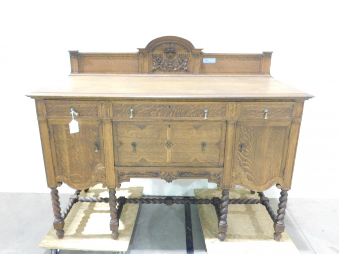 Oak Sideboard w/ Ornate Backsplash & Barley-Twist Legs: Beautiful ornate oak sideboard with fancy backsplash, scrollwork and barley-twist turned legs. Brass hardware. 2 drawers, 2 doors. Approx. 60 inches wide, 25 inches deep, 49 1/2 inches tall. Very good
