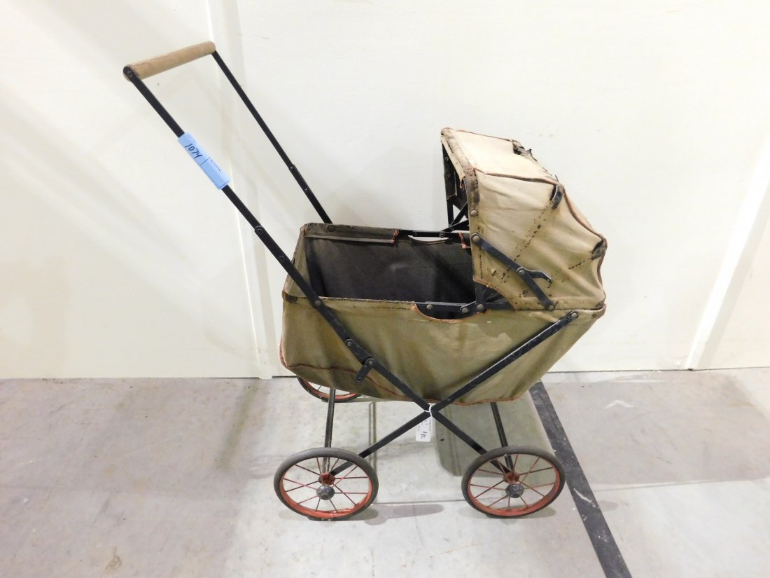 Vintage Stroller: Vintage metal and cloth stroller on steel & rubber wheels. Metal frame and wheels are in good condition. Cloth shows wear, has tears, see pictures.