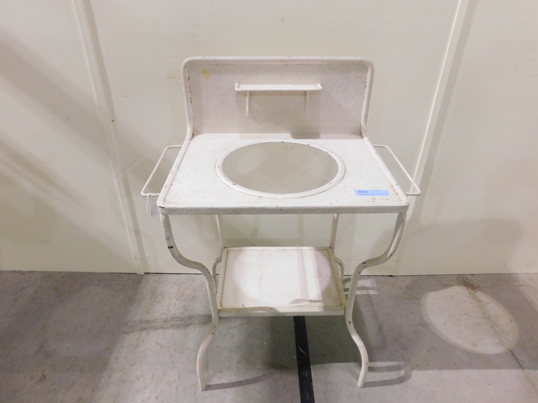 Metal Wash Bowl Stand: Early heavy metal wash bowl stand with backsplash. Approx. 29 inches wide, 18 inches deep, 40 inches tall. Painted white. Minor paint loss, shows wear. Overall good condition. Last picture shows wash 