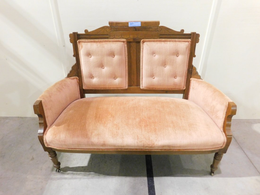 Eastlake Settee: Eastlake settee, with padded seat, back and arms in salmon color. Approx. 50 inches wide. Overall very good condition.
