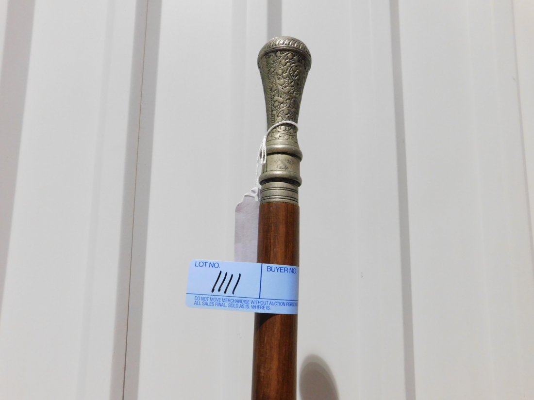 Gentleman: Gentleman's ornate walking cane, approx. 38 inches long. Silver tone handle threaded on. Ornate carving with brass inlays, metal tip. Damage repair near tip, see pictures. Otherwise good condition.
