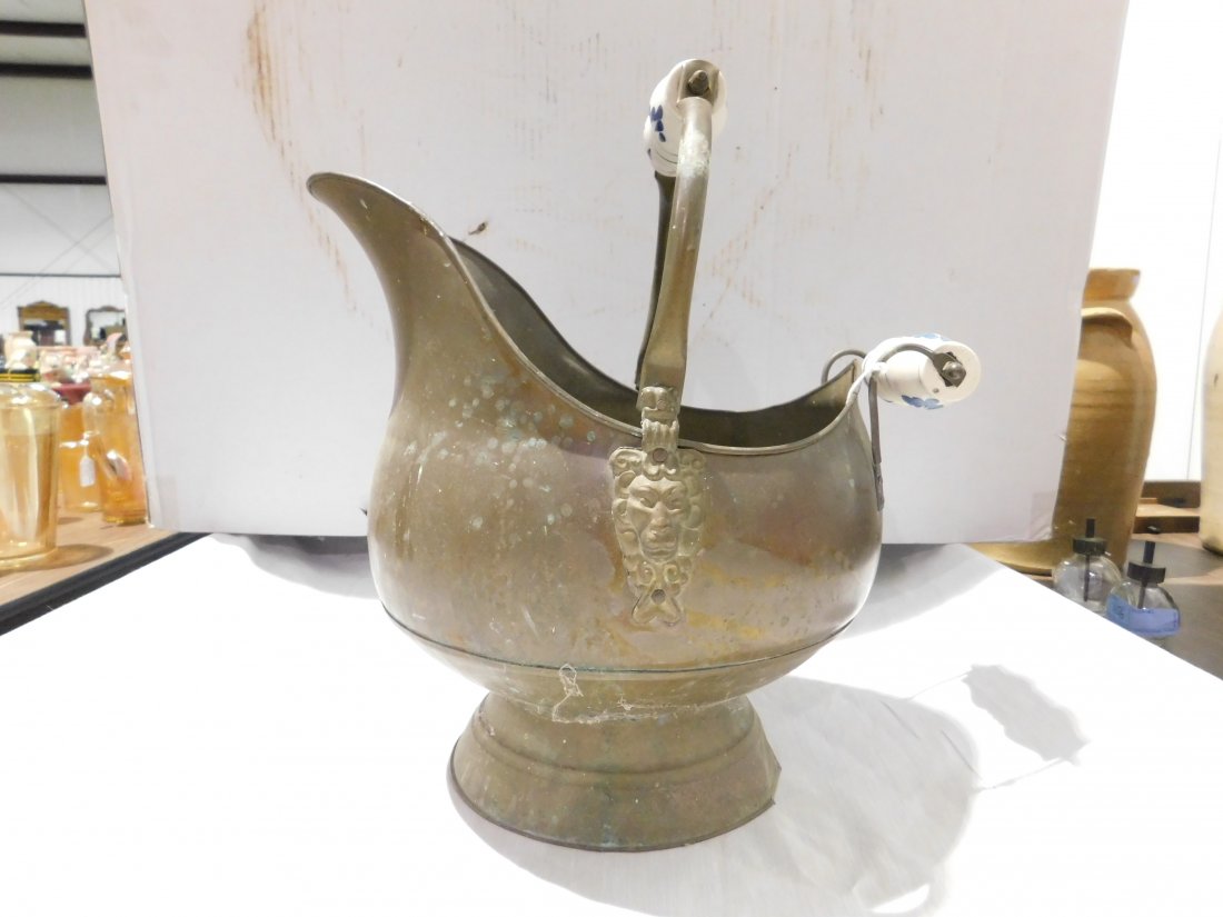 large brass ash bucket: very nice large brass ash bucket with brass and ceramic handles. Lions heads on sides. Approx. 12 1/2" tall(plus handle) 14" long 12" wide, Excellent condition