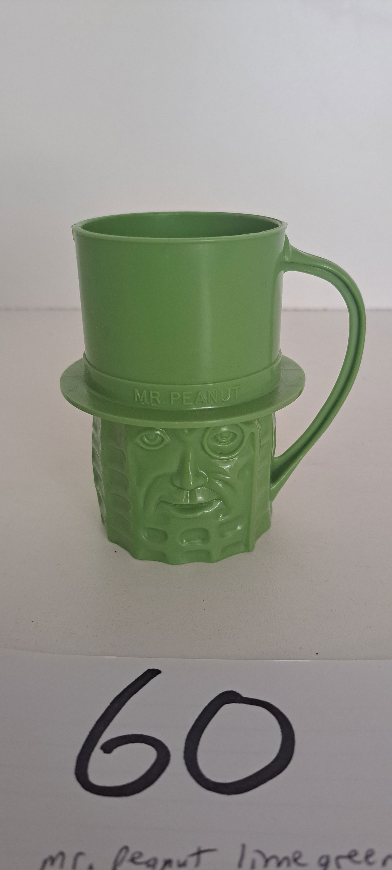 Mr. Peanut lime green cup: Mr. Peanut lime green, plastic cup, with handle, excellent condition, no chips or cracks, approx. 4" tall, please verify auction location for pick up