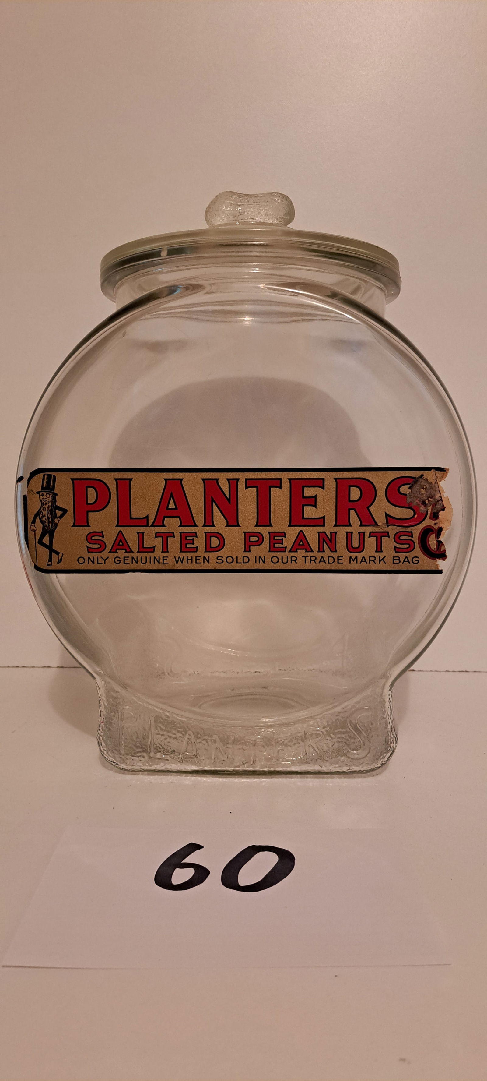 Planters Peanuts glass counter jar with label: Planters Peanuts fishbowl style, glass counter jar with original paper label, lid with peanut shaped handle, approx. 13" tall, minor loss to label, no chips, or cracks, please verify auction location