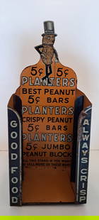Planters Peanut tin display: early, Planters Peanut, counter top die-cut, tin display, originally held Planters jumbo block bars, Mr. Peanut predominantly displayed top center, approx. 12" tall, has light wear, rust at his neck,