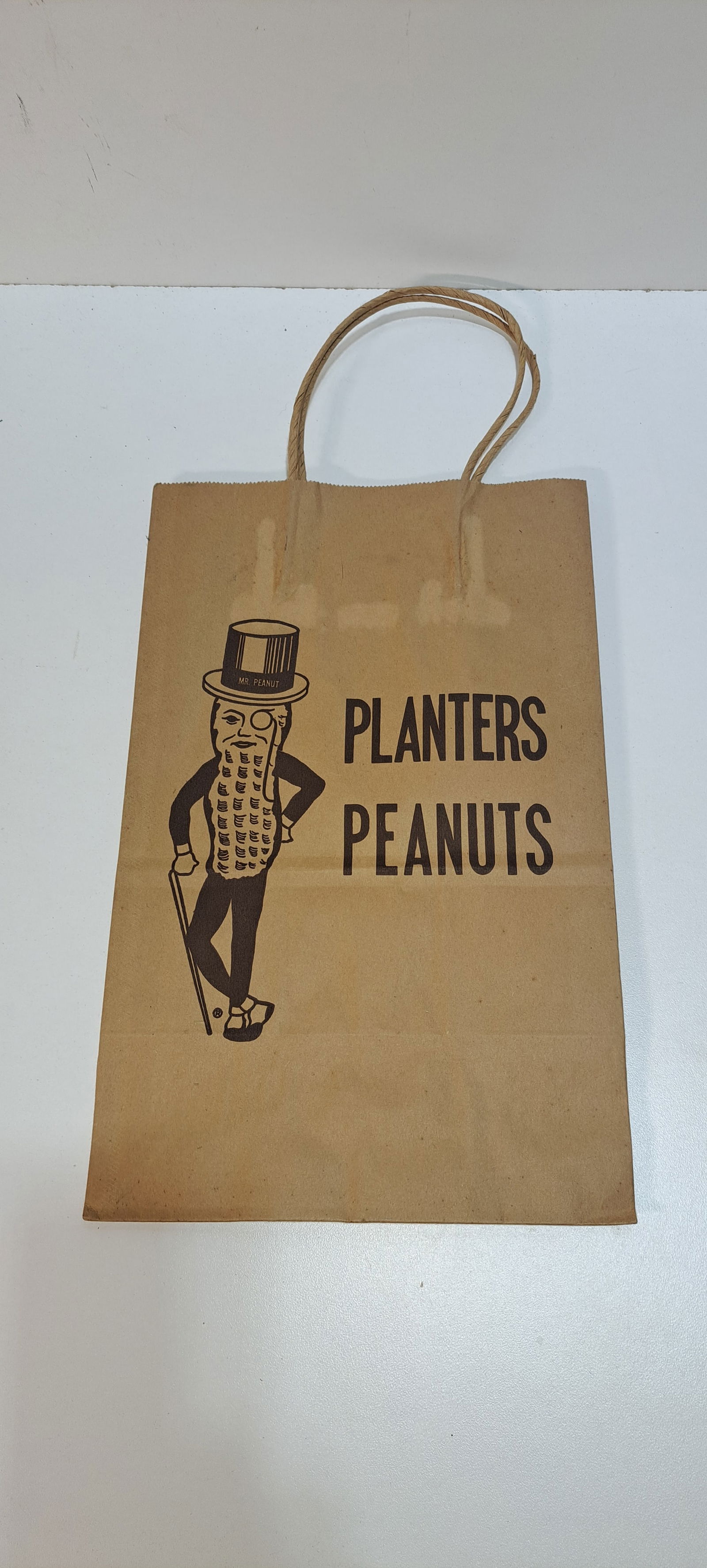 Mr. Peanut shopping bag: unused, paper shopping bag with Mr. Peanut and Planters Peanuts printed on both sides, with handles, used in the Planters Peanut stores, approx. 9"x 14" plus handles, very good condition, Please