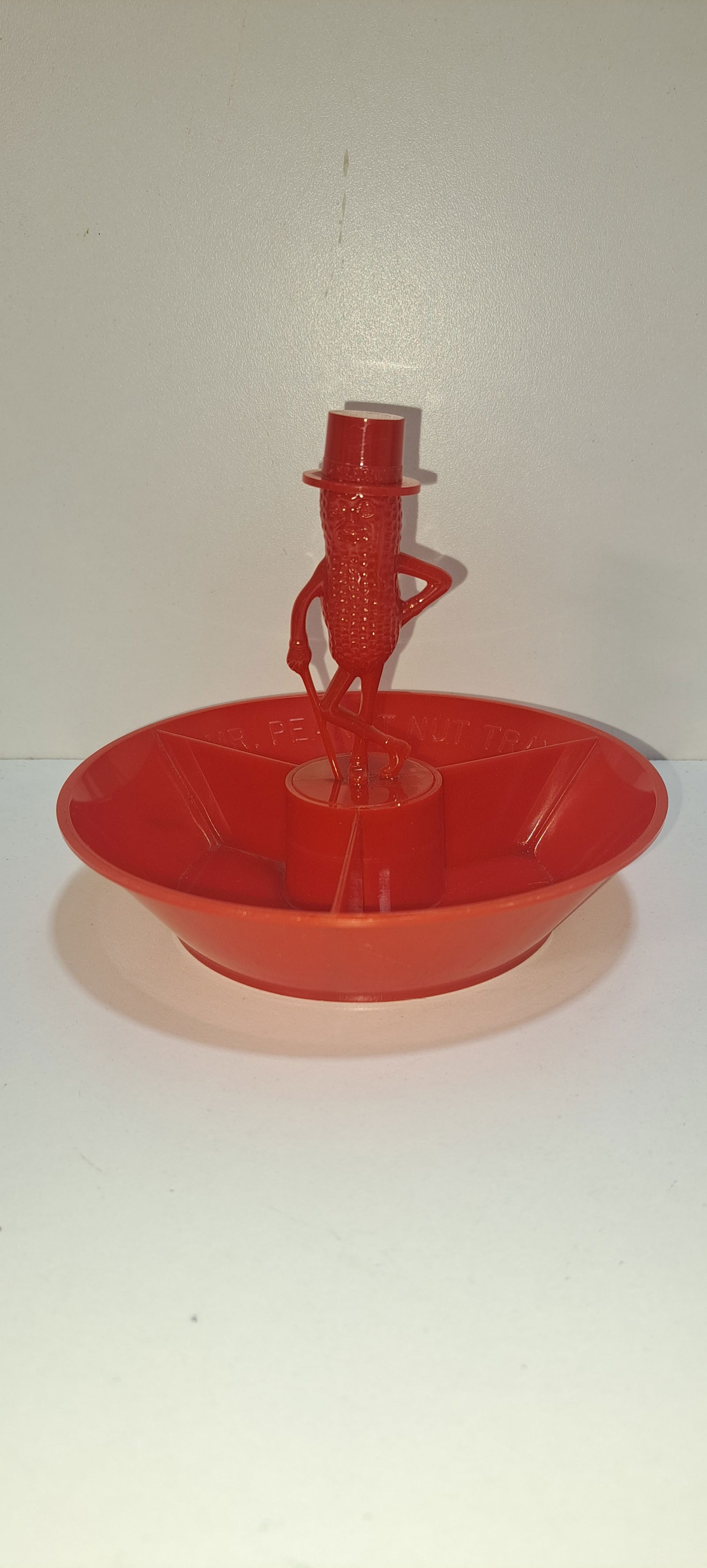 Mr. Peanut 3 compartment nut dish: red, plastic, divided nut dish with figural Mr. Peanut in the center, good condition, no chips or cracks, approx. 5" diameter, 4" tall, Please note: if picking up, location is different than auction