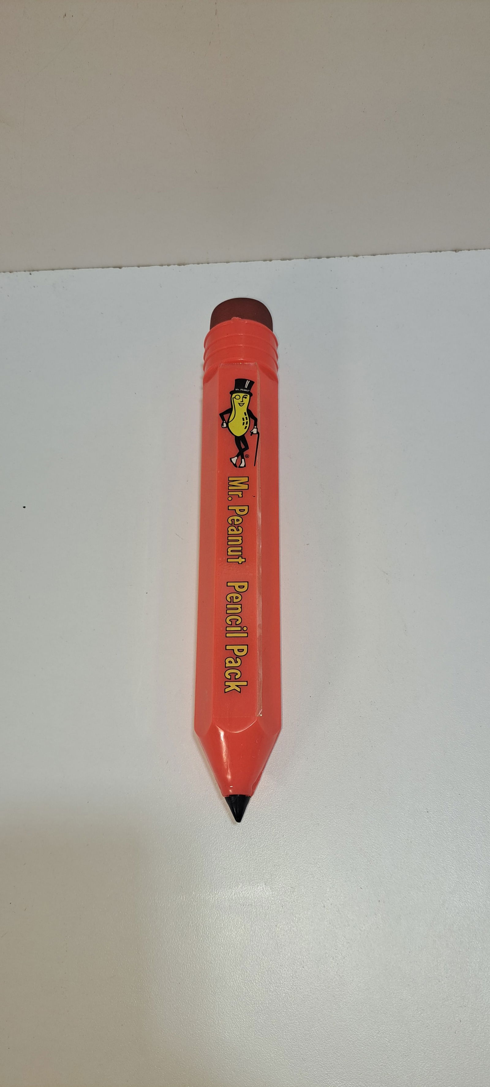 Mr. Peanut pencil pack: pink, plastic, pencil shaped pencil holder, advertising Mr. Peanut with 10 NOS. Mr. Peanut pencils inside, very good condition, no chips or cracks, approx. 10.25" long, Please note: if picking up,