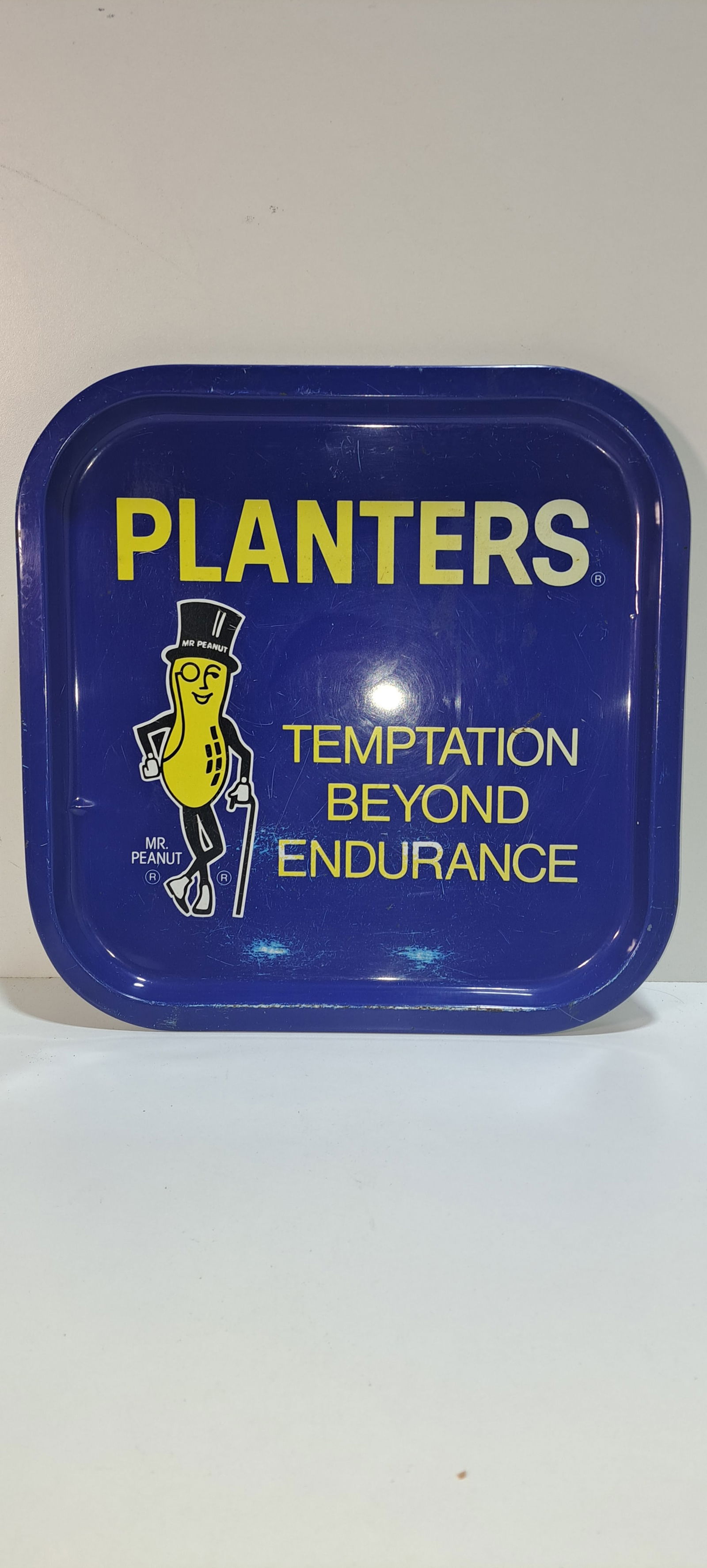 Mr. Peanut advertising tray: metal Planters Peanut advertising tray, "Temptation Beyond Endurance", good condition with minor wear as shown, approx. 13.75" x 13.75", Please note: if picking up, location is different than auction