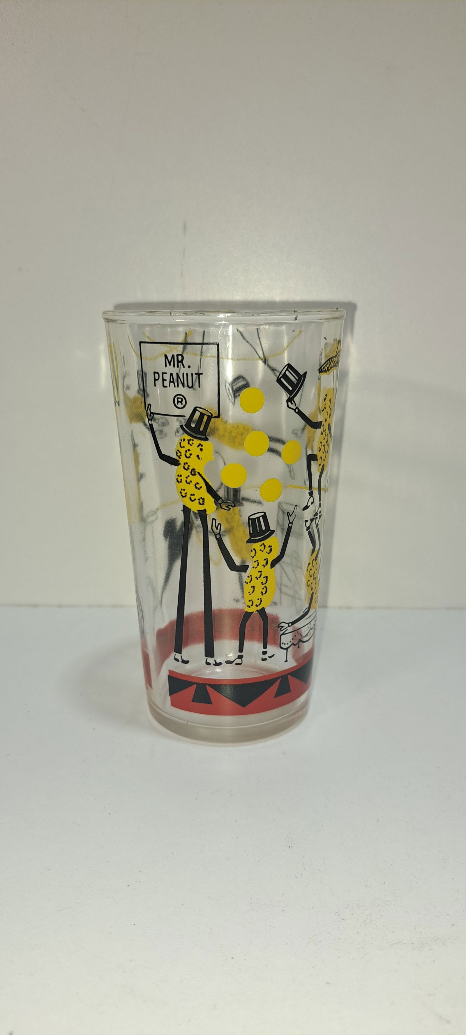Planters Peanuts circus glass: clear drinking glass with Mr. Peanut doing various circus acts, originally held peanut butter, this is the "long leg" version, excellent condition, no chips or cracks, approx. 5" tall, Please note: