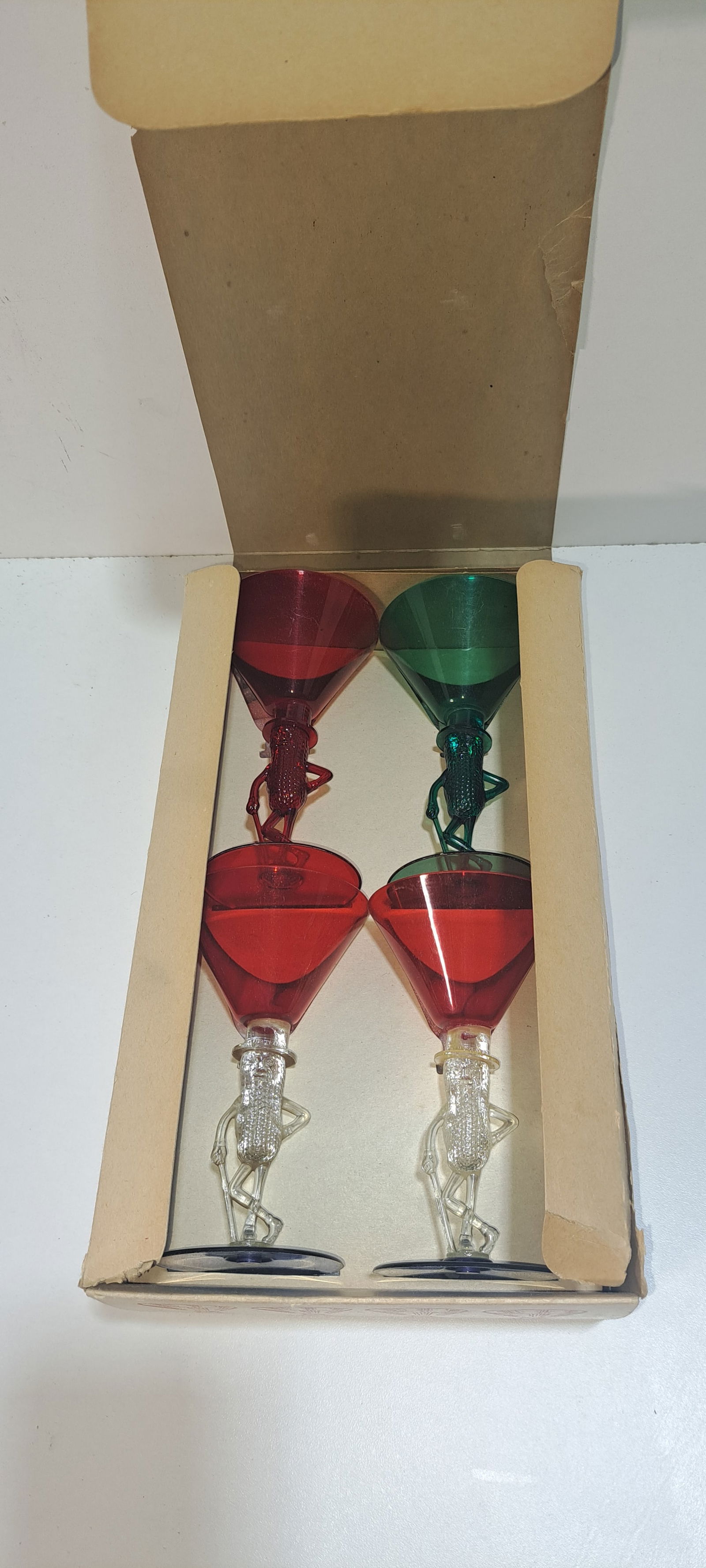 Mr. Peanut cocktail glasses in box: lot of 4 plastic, figural, Mr. Peanut cocktail glasses, in original cardboard box, glasses show minor wear, box has minor damage as shown, box is approx. 6.75" x 11.25" x 3.5", Please note: if