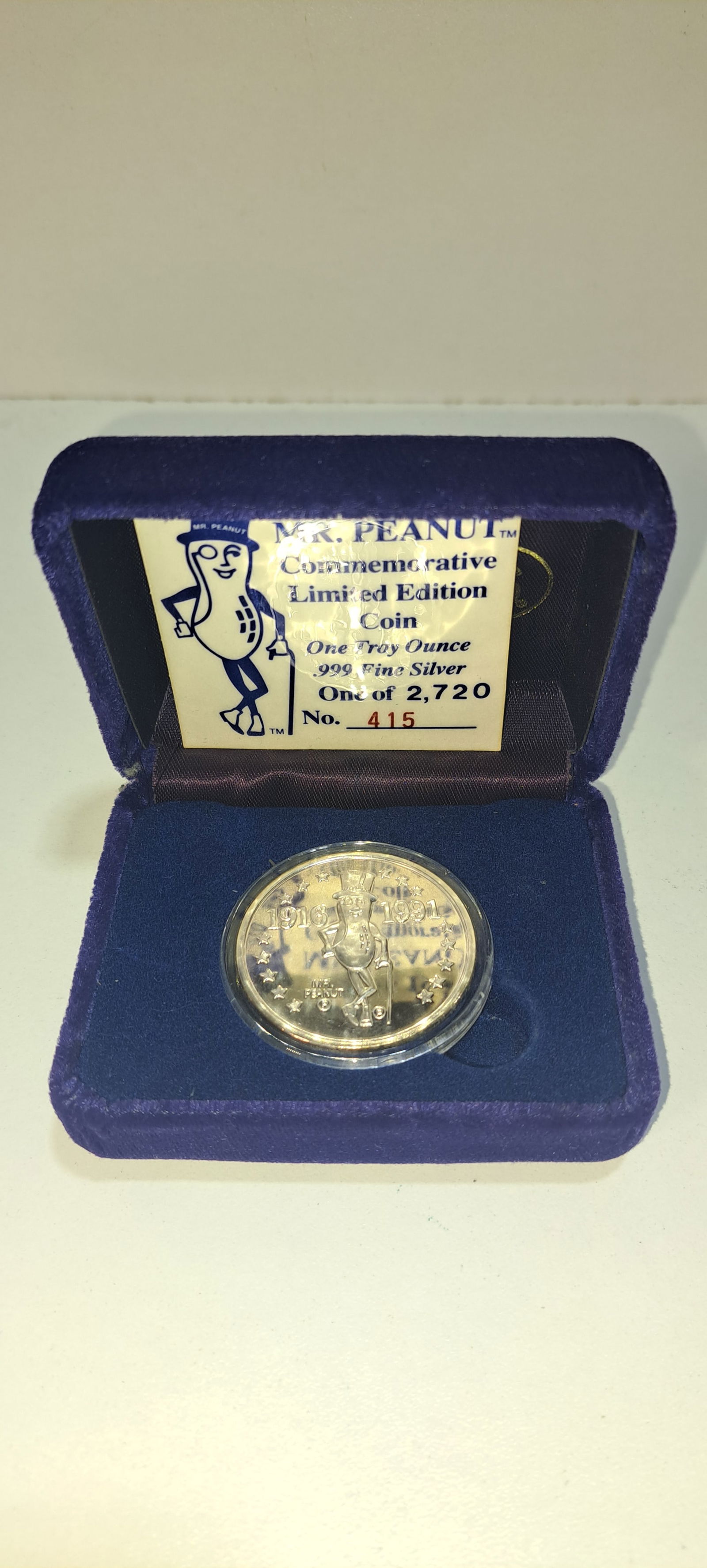 Mr. Peanut limited edition silver coin: Mr. Peanut, limited edition, one troy ounce, .999 fine silver coin, #415 of 2,720, commemorating Mr. Peanut's 75th birthday, in original velvet box, very good condition, Please note: if picking up,