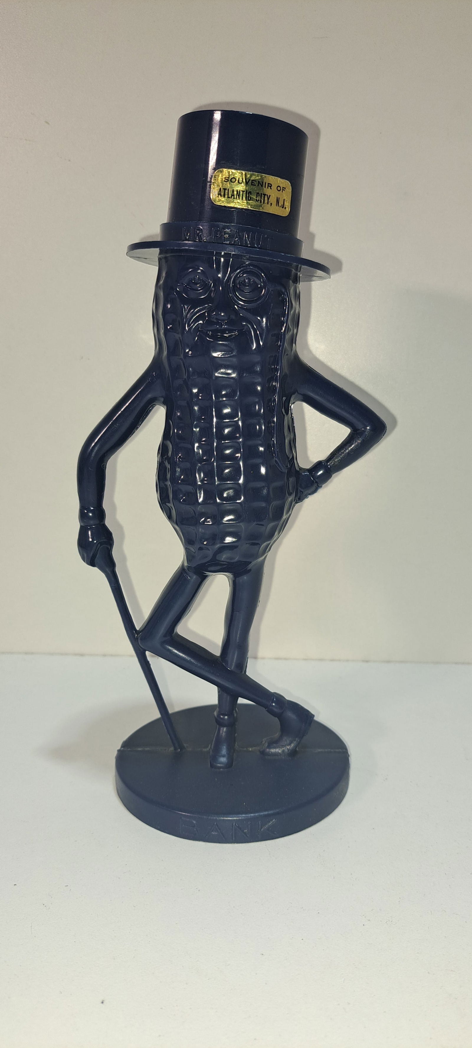 navy blue Mr. Peanut bank: navy blue, plastic, figural Mr. Peanut coin bank, souvenir of Atlantic City sticker on hat, very good condition, approx. 8.5" tall, Please note: if picking up, location is different than auction