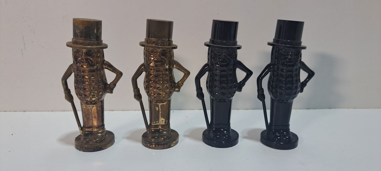 2 sets Mr. Peanut salt and pepper shakers: 2 sets of plastic, figural, Mr. Peanut salt and pepper shakers in harder to find colors, one set gold tone, has some wear, one set in black, good condition, each approx. 4" tall, Please note: if